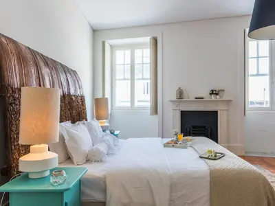 a bedroom with a bed with a table and a fireplace at Down2Town B&B in Porto