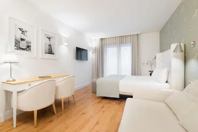 a hotel room with a bed and a desk and a couch at Eurostars Porto Douro in Porto