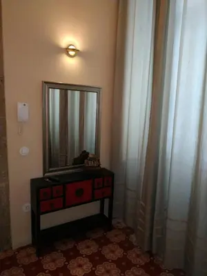 a mirror on a dresser in a room with curtains at ML Apartments Story in Porto