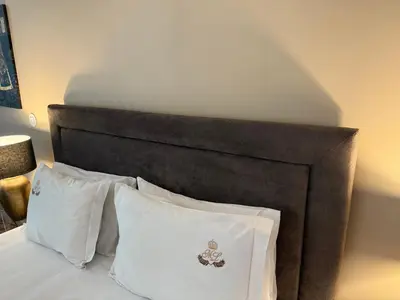 a bed with a black head board with white pillows at ML Apartments Story in Porto