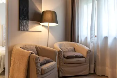 a living room with two chairs and a lamp at BmyGuest - Santa Catarina Downtown Apartment in Porto
