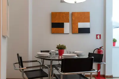 a dining room with a table and chairs at BmyGuest - Santa Catarina Downtown Apartment in Porto