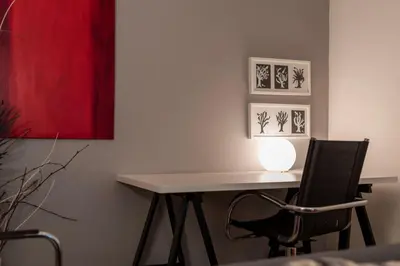 a table and a chair with a lamp on it at BmyGuest - Santa Catarina Downtown Apartment in Porto