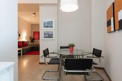 a dining room with a glass table and chairs at BmyGuest - Santa Catarina Downtown Apartment in Porto