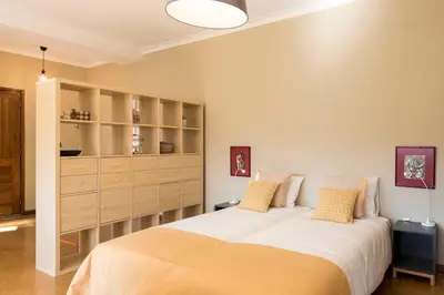 a bedroom with two beds and a large cabinet at BmyGuest - Santa Catarina Light Apartment in Porto