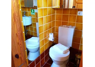 a bathroom with two toilets and a sink at Porto Alegria Garden in Porto
