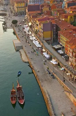 two boats are docked in the water next to buildings at BmyGuest - Cardosas Stylish Apartment in Porto