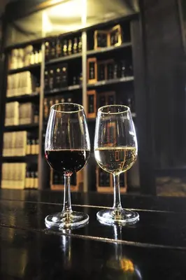 two glasses of wine sitting on a table at BmyGuest - Cardosas Stylish Apartment in Porto