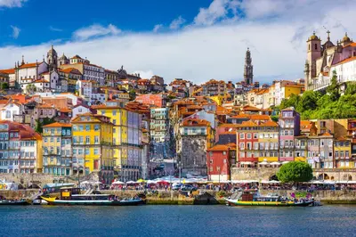 a city with colorful buildings and boats in the water at BmyGuest - Cardosas Stylish Apartment in Porto