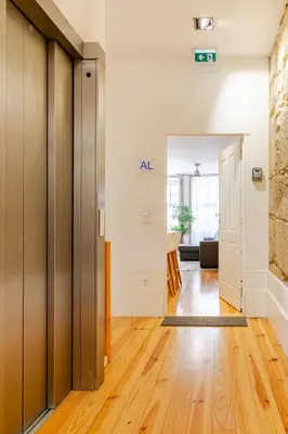 a hallway with wooden floors and a door to a room at Oporto Golden View Ribeira in Porto