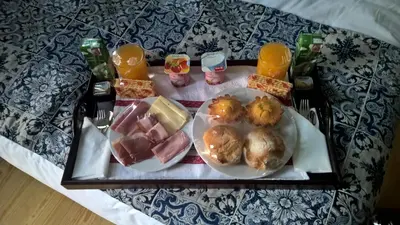 a tray with two plates of food on a table at Dukes Corner Guest House in Porto