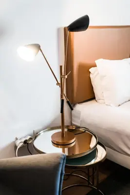a lamp on a glass table next to a bed at Downtown Residence by Apartments2Enjoy in Porto