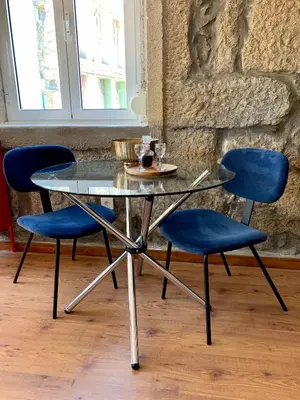 a glass table with four blue chairs around it at Downtown Residence by Apartments2Enjoy in Porto