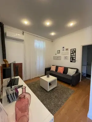 a living room with a couch and a table at Burgães II Apartment in Porto