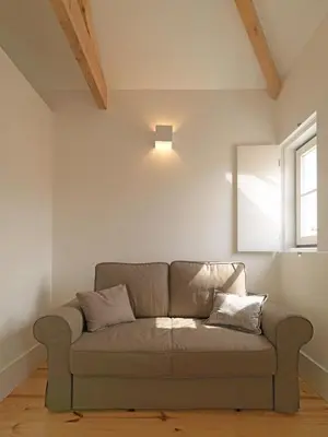 a couch in a living room with a window at FLH Porto Modern Rooftop in Porto