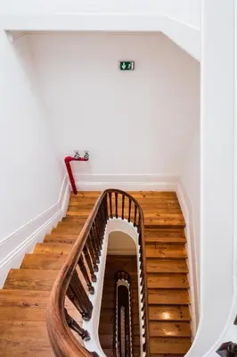 a spiral staircase in a house with wooden floors at VIVA Almada Flats in Porto