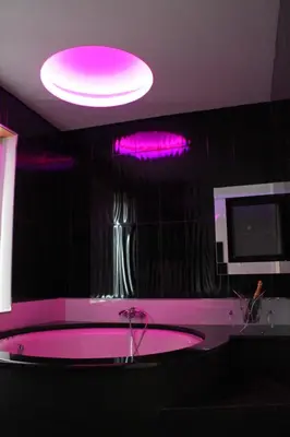 a pink bath tub in a bathroom with pink lighting at Monte Carlo Love Porto in Porto