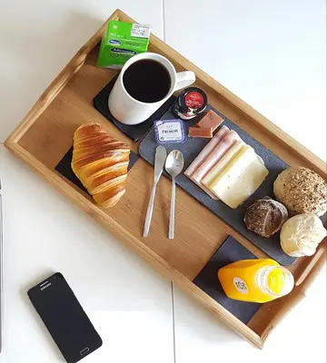 a tray with breakfast foods and a cup of coffee at LivingPorto Apartments by Porto City Hosts in Porto