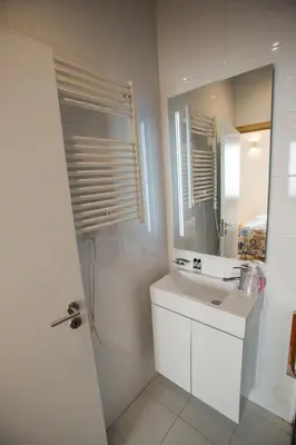 a white bathroom with a sink and a mirror at LivingPorto Apartments by Porto City Hosts in Porto