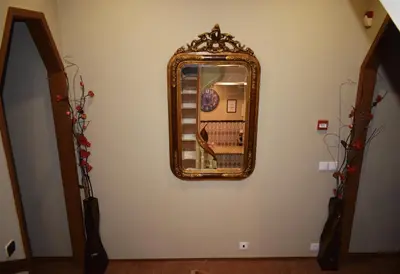 a mirror on a wall in a room at GuestHouse Belo Horizonte in Porto