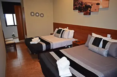 a hotel room with two beds in a room at GuestHouse Belo Horizonte in Porto