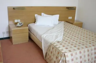 a hotel room with a bed and a telephone at Hotel Douro in Porto