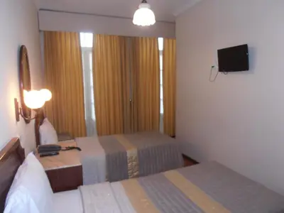 a hotel room with two beds and a television at Hotel S. Marino in Porto