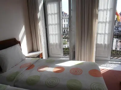 a bedroom with a bed with an open window at Hotel S. Marino in Porto