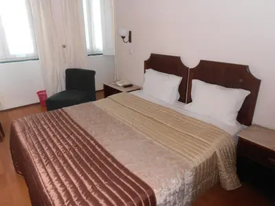 a hotel room with a bed and a chair at Hotel S. Marino in Porto