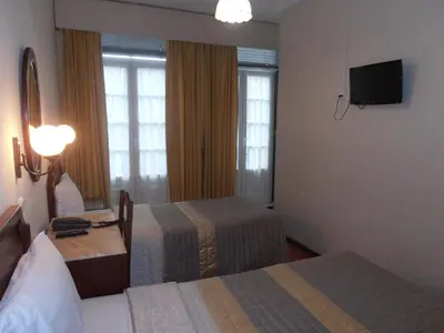 a hotel room with two beds and a television at Hotel S. Marino in Porto