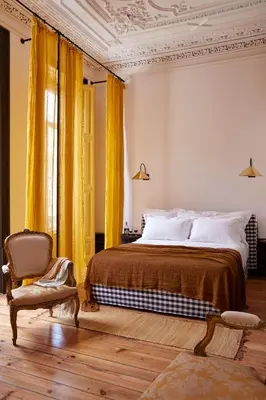 a bedroom with a bed and a chair at Cocorico Luxury House - Porto in Porto