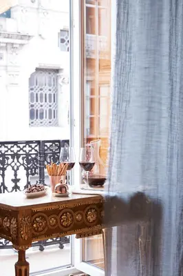 a table with two glasses of wine on a balcony at Cocorico Luxury House - Porto in Porto