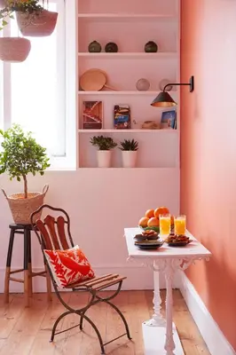 a table and a chair in a room with pink walls at Cocorico Luxury House - Porto in Porto