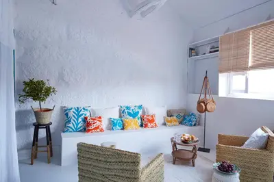 a living room with a couch with colorful pillows at Cocorico Luxury House - Porto in Porto