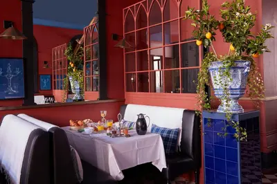 a table in a restaurant with a white table cloth at Cocorico Luxury House - Porto in Porto