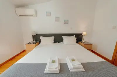 a bedroom with a large white bed with two pillows at Dear Porto By Hosty in Porto