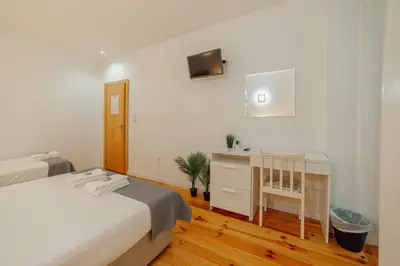 a bedroom with a bed and a dresser and a desk at Dear Porto By Hosty in Porto