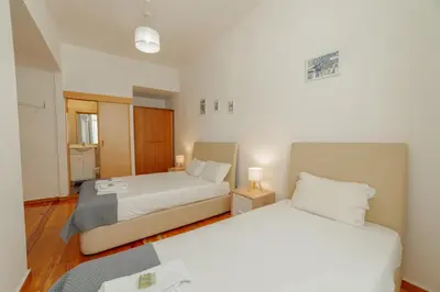 two beds in a small room with two lamps at Dear Porto By Hosty in Porto