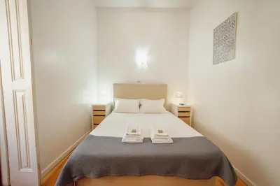 a bedroom with a bed with two shoes on it at Dear Porto By Hosty in Porto