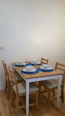 a dining room table with chairs and plates on it at D&S - Crocodile House S. Bento Apartments in Porto