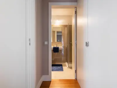 a hallway leading to a bathroom with a shower at Cardosas Boutique Apartment in Porto