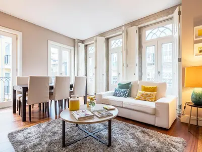 a living room with a white couch and a table at Cardosas Boutique Apartment in Porto