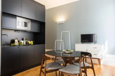 a kitchen and dining room with a table and chairs at bnapartments Carregal in Porto