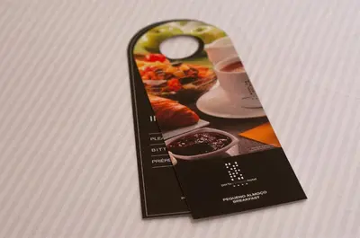 a black tag with a picture of a plate of food at Porto Trindade Hotel in Porto
