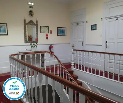 a staircase in a house with a sign that says clean and safe at Hotel Mira D'Aire in Porto