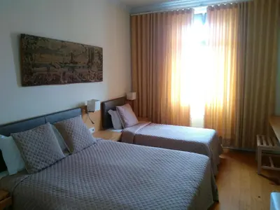 a hotel room with two beds and a window at Hotel Mira D'Aire in Porto