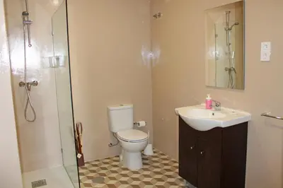 a bathroom with a toilet and a sink and a shower at Lunar Guest House in Porto