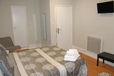 a bedroom with a bed with towels on it at Lunar Guest House in Porto