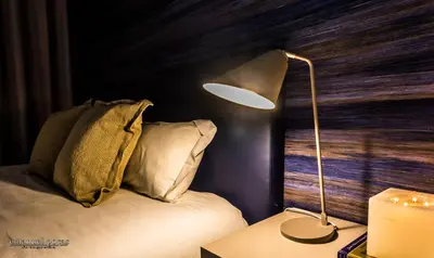 a lamp sitting on a table next to a bed at Passos Manuel by Innapartments in Porto