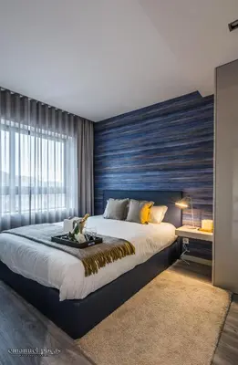 a bedroom with a large bed and a large window at Passos Manuel by Innapartments in Porto